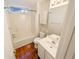 Bathroom with hardwood floors, vanity, tub and window at 6025 Ashbury Ln, Cumming, GA 30028