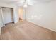 A bright bedroom is carpeted and includes a ceiling fan and closet at 6025 Ashbury Ln, Cumming, GA 30028