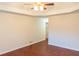 Minimalist bedroom with hardwood floors, ceiling fan, and neutral tones at 6025 Ashbury Ln, Cumming, GA 30028