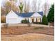 Charming single-story home with manicured front lawn and attached two-car garage at 6025 Ashbury Ln, Cumming, GA 30028