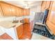Well-equipped kitchen with a breakfast bar, stainless steel appliances, and wood cabinets at 6025 Ashbury Ln, Cumming, GA 30028