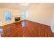 Cozy living room with a stone fireplace and hardwood flooring at 6025 Ashbury Ln, Cumming, GA 30028