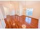 Bright living room featuring hardwood floors, high ceilings, and elegant light fixtures at 6025 Ashbury Ln, Cumming, GA 30028