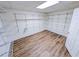 A large walk-in pantry features extensive shelving and wood-look floors at 6025 Ashbury Ln, Cumming, GA 30028