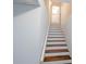 Staircase with hardwood treads, leading to the upper level at 6025 Ashbury Ln, Cumming, GA 30028