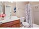 This bathroom features a vanity, toilet, and shower with curtain, all with neutral walls and tile floors at 37 Jekyll Dr, Marietta, GA 30066