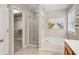 An airy full bathroom features a soaking tub, glass shower, and beachy decor at 37 Jekyll Dr, Marietta, GA 30066