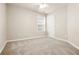 The carpeted bedroom has neutral colored walls, a ceiling fan and a window for natural light at 37 Jekyll Dr, Marietta, GA 30066