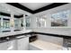 Luxurious bathroom featuring a soaking tub, black marble countertops, and bright white cabinetry under two windows at 81 Peachtree Ne Cir, Atlanta, GA 30309