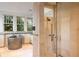 Modern bathroom featuring a walk-in shower, stand-alone tub, and plenty of natural light at 81 Peachtree Ne Cir, Atlanta, GA 30309