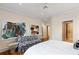 Bright bedroom featuring neutral walls, hardwood flooring, modern art pieces, and a comfortable patterned sofa at 81 Peachtree Ne Cir, Atlanta, GA 30309