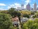 Scenic aerial shot of homes nestled among lush trees, set against the city skyline at 121 17Th Ne St, Atlanta, GA 30309