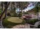 Private backyard with a putting green, deck, stone patio and lush landscaping at 121 17Th Ne St, Atlanta, GA 30309