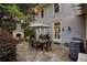 Backyard patio featuring a stone fireplace, dining set, outdoor grill, and elegant exterior home details at 121 17Th Ne St, Atlanta, GA 30309