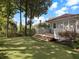 Backyard with a putting green and a wooden deck overlooking a serene landscape with mature trees at 121 17Th Ne St, Atlanta, GA 30309