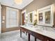 Bathroom featuring a double vanity with marble countertop, mirrors, and modern lighting at 121 17Th Ne St, Atlanta, GA 30309