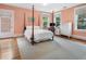 Bright bedroom featuring a four-poster bed, hardwood floors, and ample natural light at 121 17Th Ne St, Atlanta, GA 30309