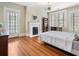 Bedroom showcasing natural light, hardwood floors, and a fireplace at 121 17Th Ne St, Atlanta, GA 30309