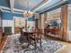 Formal dining room with large windows, hardwood floors, and antique furnishings, a beautiful space to entertain at 121 17Th Ne St, Atlanta, GA 30309