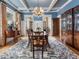 Elegant dining room with coffered ceiling, chandelier, and classic furnishings, perfect for formal gatherings at 121 17Th Ne St, Atlanta, GA 30309