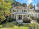 Beautiful two-story home featuring a stone facade, mature landscaping, and a welcoming front porch at 121 17Th Ne St, Atlanta, GA 30309