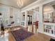 Open-concept living space with hardwood floors, built-in shelving, and large windows, perfect for entertaining at 121 17Th Ne St, Atlanta, GA 30309