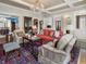 Bright living room with classic furnishings, ornate rug, chandelier, and architectural details at 121 17Th Ne St, Atlanta, GA 30309