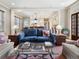 Inviting living room with hardwood floors, comfortable seating, and an open view into the dining area and kitchen at 121 17Th Ne St, Atlanta, GA 30309