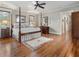 Spacious main bedroom with a four-poster bed, hardwood floors, and elegant furnishings at 121 17Th Ne St, Atlanta, GA 30309