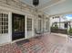 Inviting brick porch with swing, seating, and classic architectural details; ideal for relaxing outdoors at 121 17Th Ne St, Atlanta, GA 30309