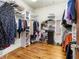 Organized walk-in closet with shelving, clothing racks, and hardwood floors at 121 17Th Ne St, Atlanta, GA 30309