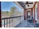 Cozy covered balcony features serene lake views and a seating area with ceiling fan at 1279 Saxony Se Dr, Conyers, GA 30013