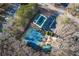 Aerial view of community pool and tennis courts, surrounded by lush greenery and parking at 17 Vickers Pl, Douglasville, GA 30134