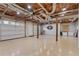 Spacious basement area with open ceiling, painted floor, and a Georgia Bulldogs logo at 17 Vickers Pl, Douglasville, GA 30134