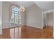 Elegant dining room with large window, hardwood floors, modern chandelier, and neutral paint at 17 Vickers Pl, Douglasville, GA 30134