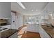 Well-lit kitchen with stainless steel appliances, light wood floors, and granite counters at 17 Vickers Pl, Douglasville, GA 30134