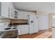 Functional kitchen equipped with white cabinets, granite countertops, and modern appliances at 17 Vickers Pl, Douglasville, GA 30134