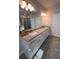 Bathroom with dual sinks, granite countertops, and a large mirror creating a bright and functional space at 1935 Manor Pointe Dr, Cumming, GA 30041