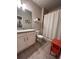 Inviting bathroom featuring a granite countertop, a vanity, a toilet with a shower-tub combo with modern finishes at 1935 Manor Pointe Dr, Cumming, GA 30041