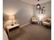 Cozy bedroom showcasing two chairs, neutral decor, and soft lighting, creating a relaxing atmosphere at 1935 Manor Pointe Dr, Cumming, GA 30041