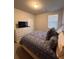 Well-lit bedroom featuring plush carpets, a comfortable bed, a window with blinds, and ample natural light at 1935 Manor Pointe Dr, Cumming, GA 30041