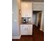 Bright, tidy coffee bar area features granite counters, white cabinets and hardwood floors at 1935 Manor Pointe Dr, Cumming, GA 30041