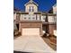 Beautiful two-story townhome with a garage and a driveway at 1935 Manor Pointe Dr, Cumming, GA 30041