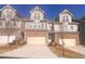 Row of attractive townhomes, each featuring a private garage and balcony at 1935 Manor Pointe Dr, Cumming, GA 30041