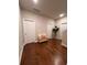 Upstairs hallway features hardwood floors, three doors, and a small bench seat at 1935 Manor Pointe Dr, Cumming, GA 30041