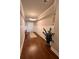 Well-lit hallway with hardwood floors, wainscoting, modern light fixture, and neutral paint at 1935 Manor Pointe Dr, Cumming, GA 30041