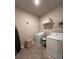 Bright laundry room featuring a modern washer and dryer set, with convenient shelving and storage at 1935 Manor Pointe Dr, Cumming, GA 30041