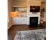 Comfortable living room with fireplace, tv, shelving and hardwood floors at 1935 Manor Pointe Dr, Cumming, GA 30041