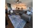 Spacious living room with ceiling fan, stairs, hardwood floors and large sectional sofa at 1935 Manor Pointe Dr, Cumming, GA 30041