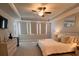 Spacious main bedroom boasting a ceiling fan, large windows, and a comfortable bed with accent pillows at 1935 Manor Pointe Dr, Cumming, GA 30041